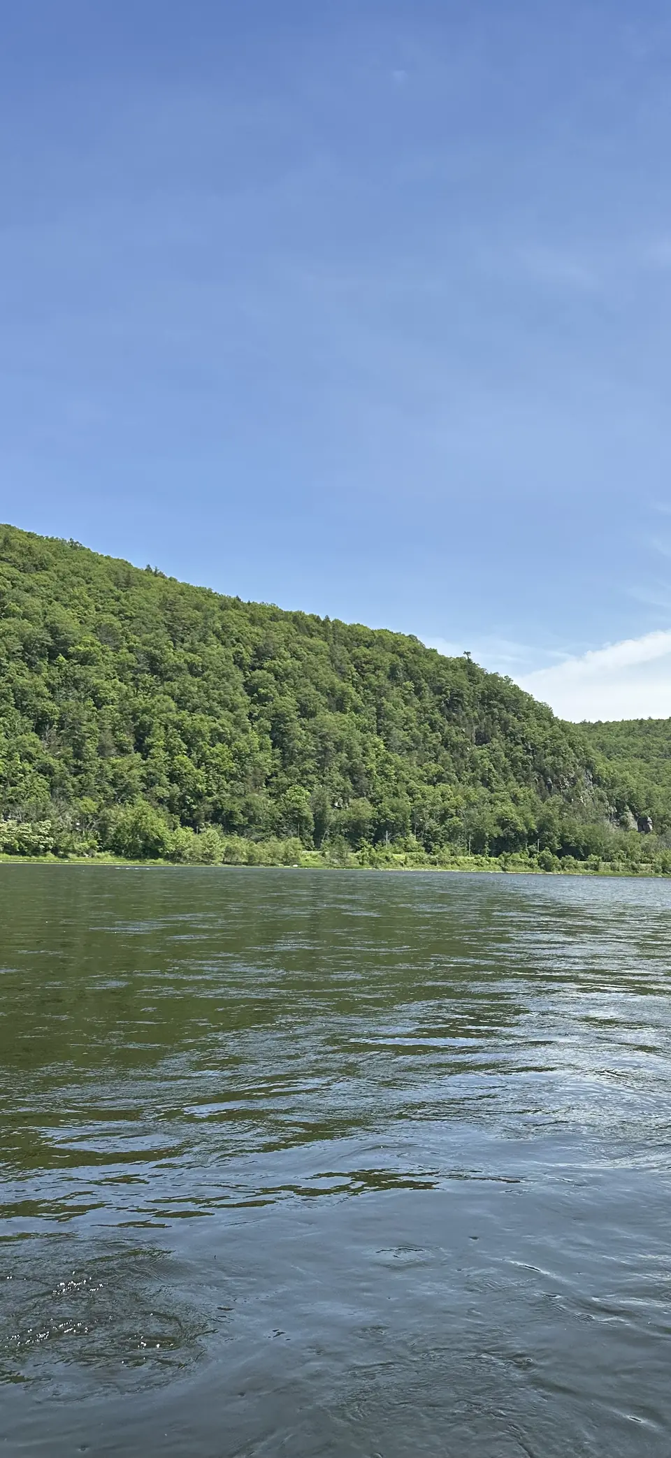 The Delaware River flowing past green hills