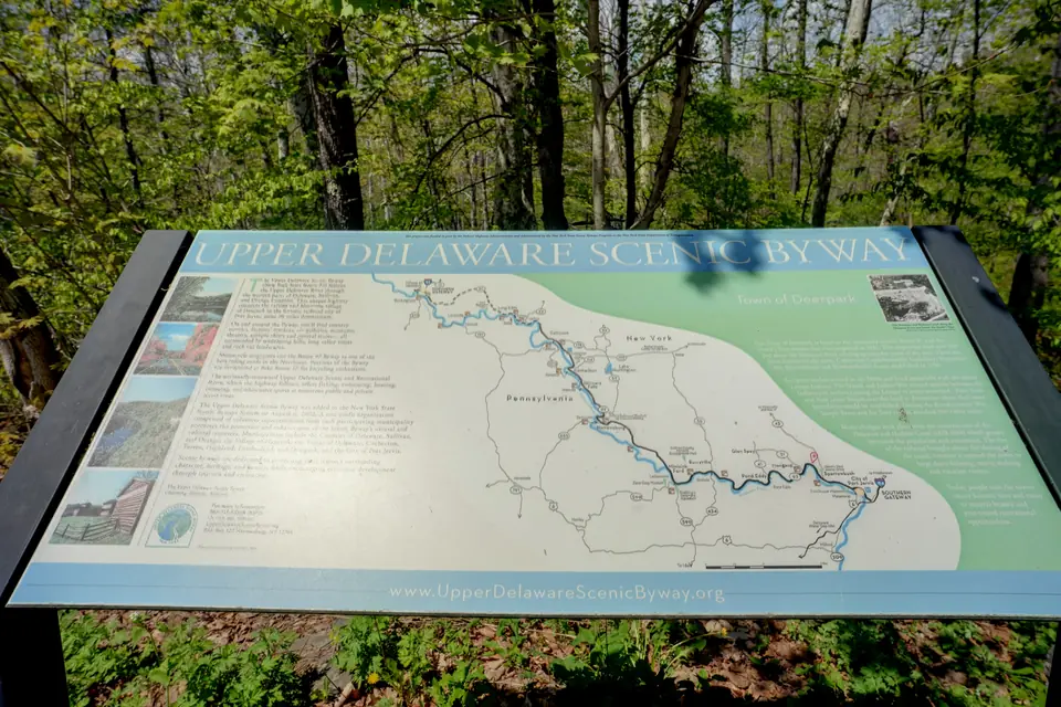 Upper Delaware Scenic Byway map sign beside the woods