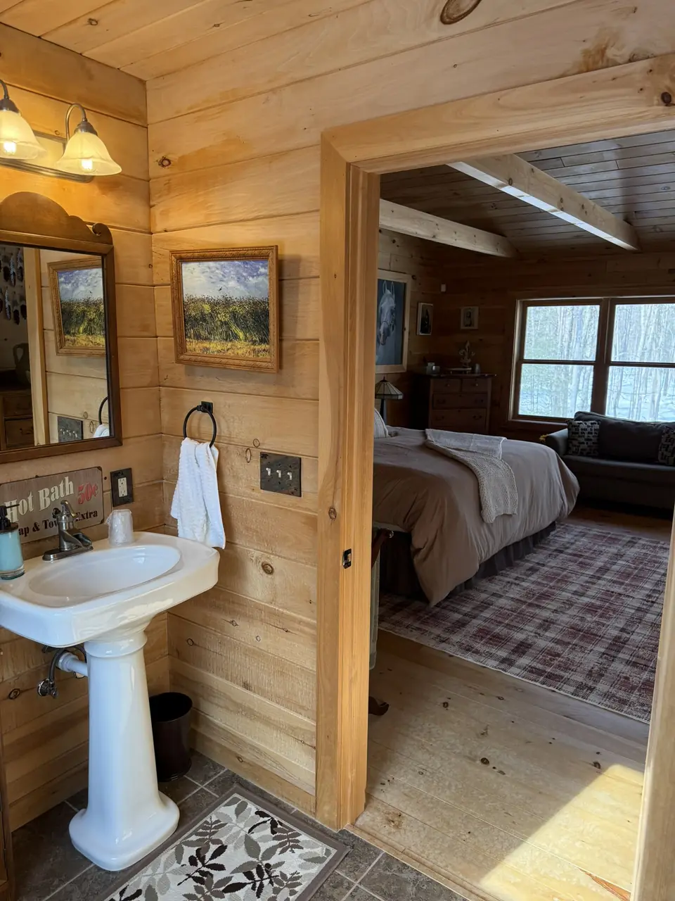Bathroom vanity with pedestal sink beside the primary bedroom