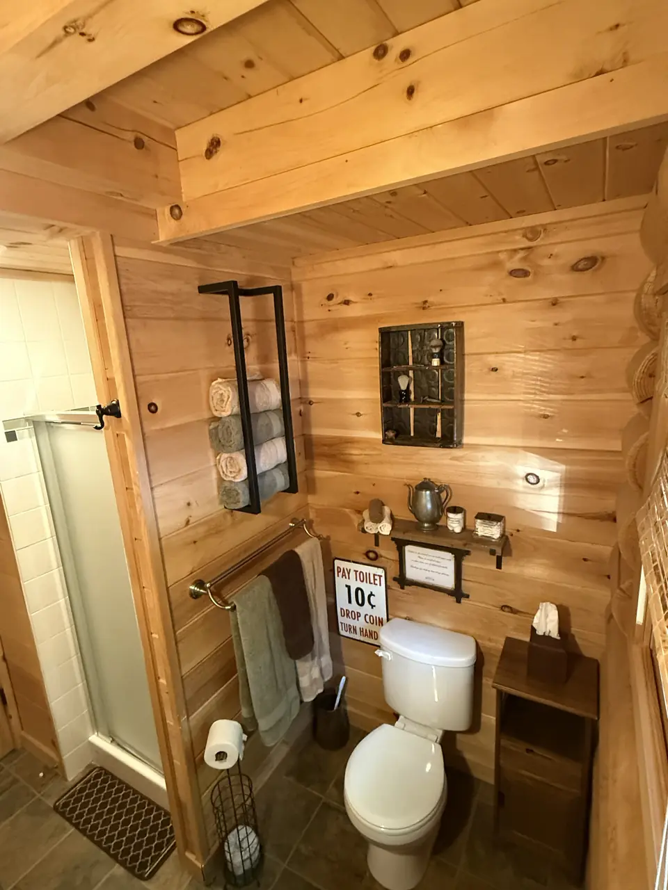 Bathroom with log walls and rustic decor