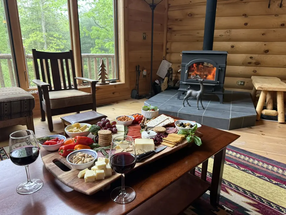 Charcuterie board and red wine beside the wood burning stove