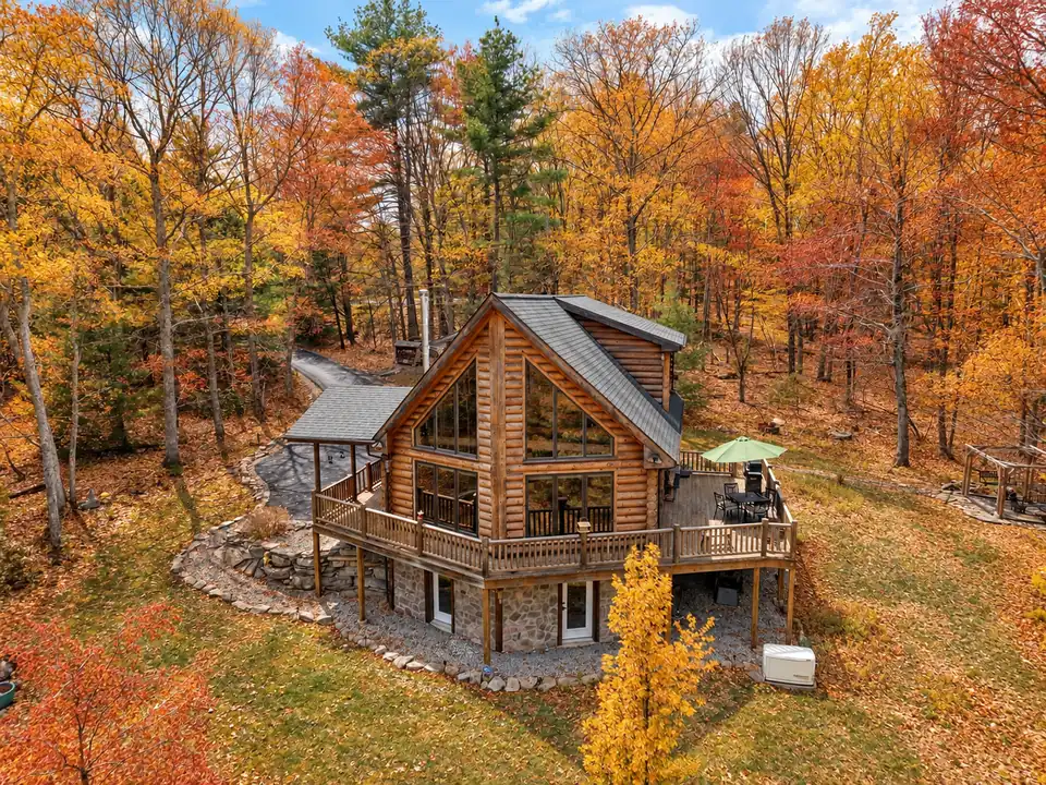 Aerial view of the Fernwood Lodge log cabin surrounded by autumn foliage