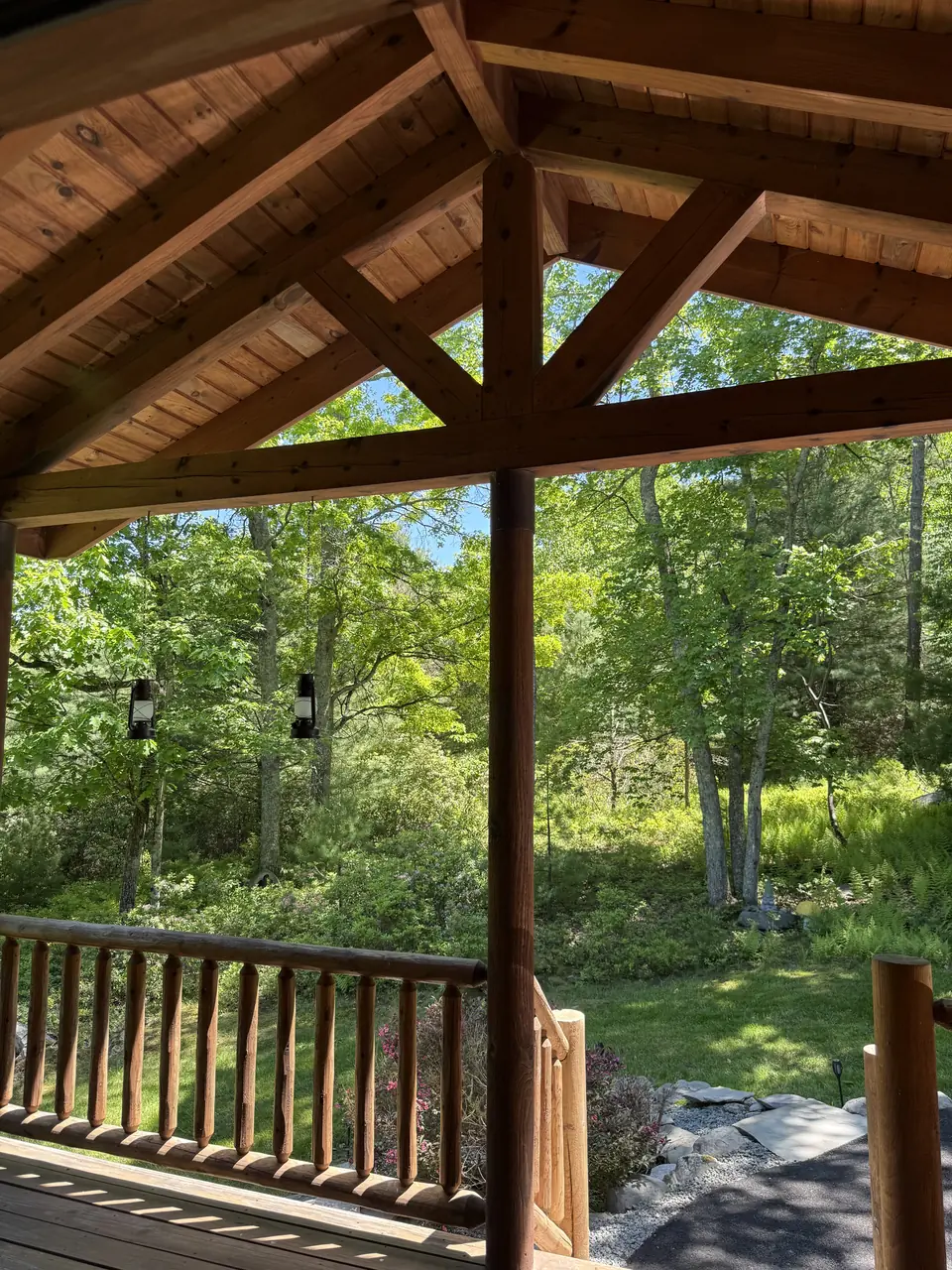 Looking out from the covered porch to the green summer woods